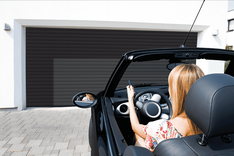 anthracite roller door with woman pushing transmitter button