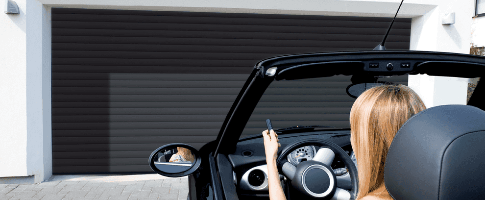 Roller door in anthracite being operated by woman in car