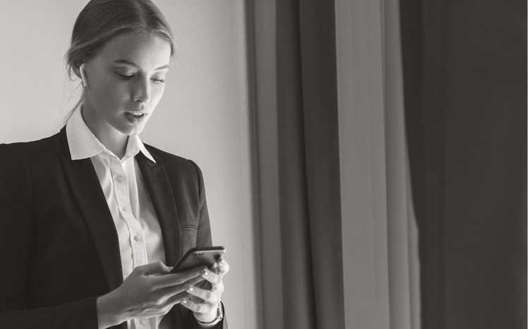 Business woman interacting with smartphone